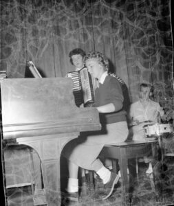 Girls sitting at a piano